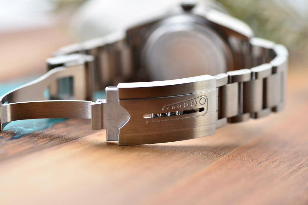 Tudor Pelagos 42 titanium folding clasp with safety catch and extension links, close-up