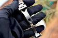 Tudor Pelagos 42 titanium folding clasp engraved with Tudor branding, held in a gloved hand