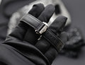 Omega Speedmaster Professional Moonwatch black leather strap and stainless steel buckle detail, close-up
