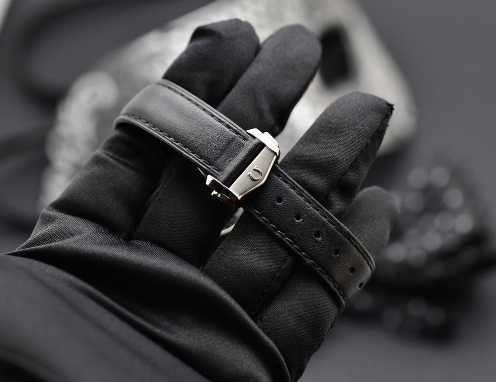 Omega Speedmaster Professional Moonwatch black leather strap and stainless steel buckle detail, close-up